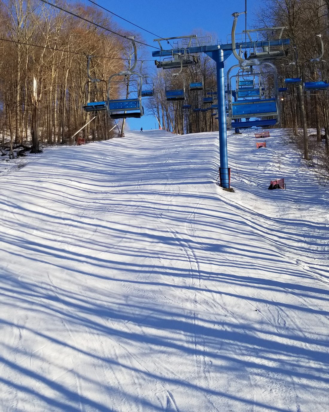 Chairlift running above a snow-covered ski slope at Shawnee Mountain in the Pocono Mountains, Pennsylvania